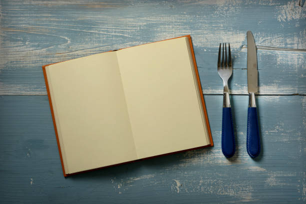 istock recipe book with blank pages with fork and knife - closeup 1082865256