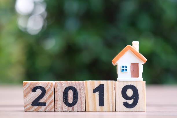 istock 2019 wooden block number and house model. 1082866614