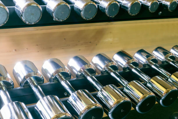 istock row of mirror dumbbells, close-up background 1082868310
