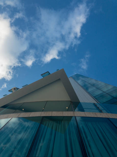 istock Modern palace architecture, reflective windows, glass palace. Sky mirrored in the windows of a building. Clouds in the sky, corners and edges of a skyscraper. 1082871152