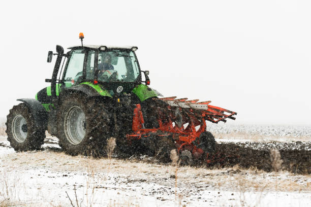 istock Tractor plowing a field in winter 1082880066