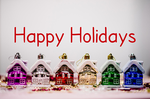Text happy holidays. Merry Christmas concept. Christmas tree decorations in form of colored europe houses, snowflakes. New Year city banners, card. blurred. Festive background, Happy New Year 2018.