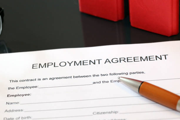 istock Blank form of an employment agreement on a desk 1082881966