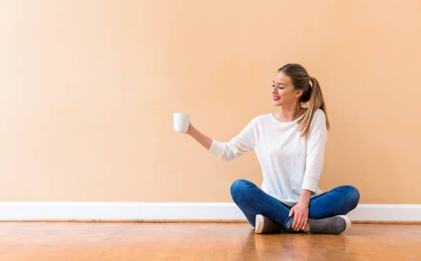 istock Young woman drinking a cup of coffee 1082883314