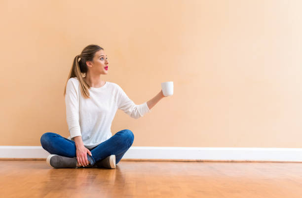 istock Young woman drinking a cup of coffee 1082883338