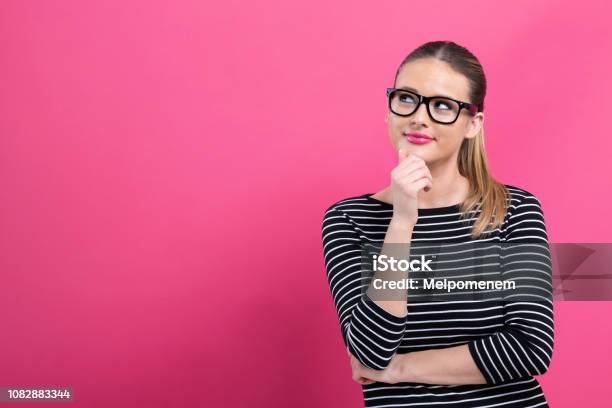 Photo libre de droit de Jeune Femme Dans Une Pose Bien Pensée banque d'images et plus d'images libres de droit de Fond - Fond, Personne humaine, État solide