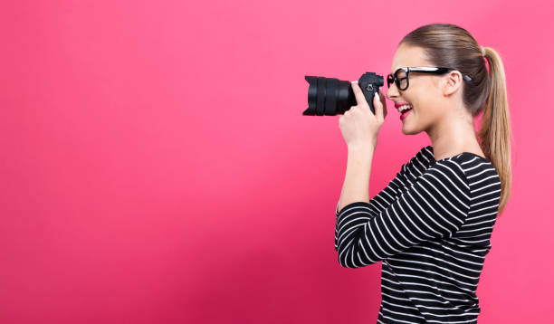 istock Young woman with a professional camera 1082883436