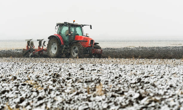 istock Tractor plowing a field in winter 1082883894