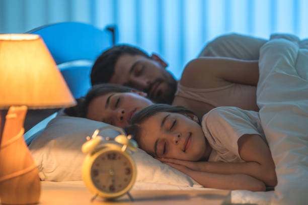 istock The happy family sleeping in the comfortable bed. night time 1082887048