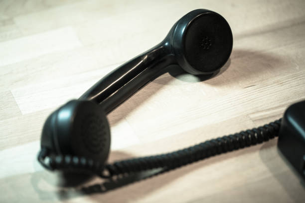 istock Telephone receiver lies on wooden table 1082887052