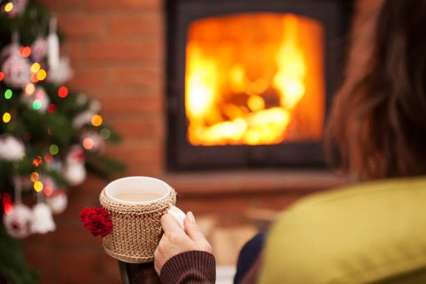 istock Enjoying a latte coffee by the fireplace at christmas time 1082887870