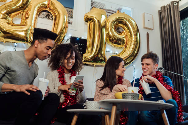 istock Teenagers using mobile phone for New year's night 1082891012