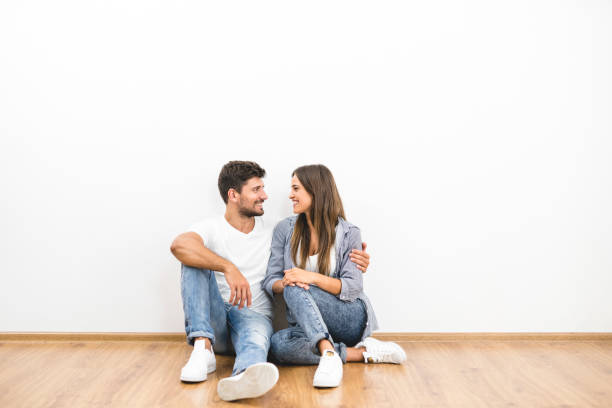 istock The happy couple sit near the white wall 1082894802