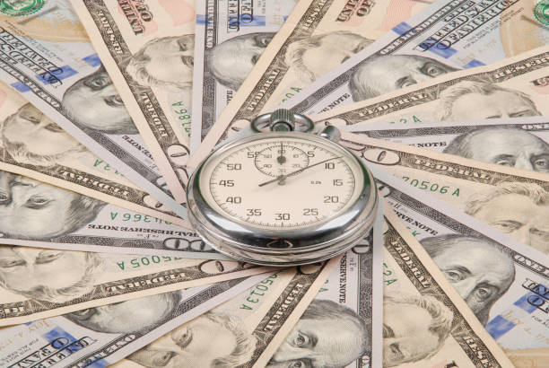 istock Stopwatch on mandala kaleidoscope from money. 1082896002