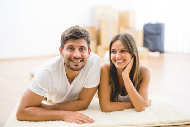istock The happy couple lay on the carpet 1082896076