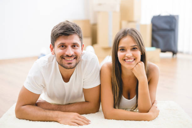 istock The happy couple lay on the carpet 1082896082