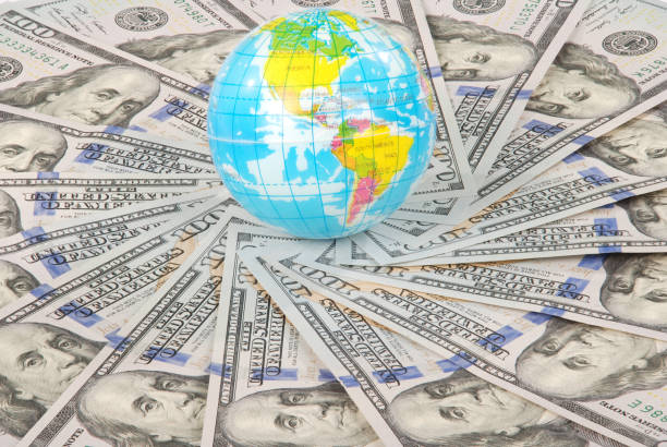 istock Earth globe on mandala kaleidoscope from money. 1082897666