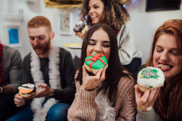 istock Young women eating cookies 1082898714