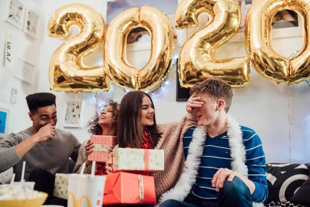 istock Happy young people holding presents 1082902892