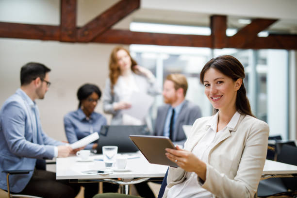 istock Young businesswoman using digital tablet and analyzing business report 1082909390