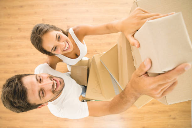 istock The man and woman hold a boxes. view from above 1082909596