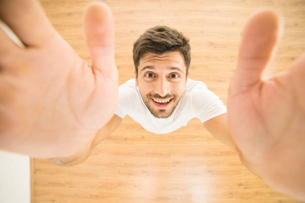 The happy man hold a camera. view from above