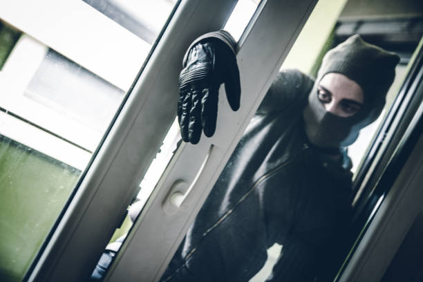 istock Burglar Breaking Into House 1082924386