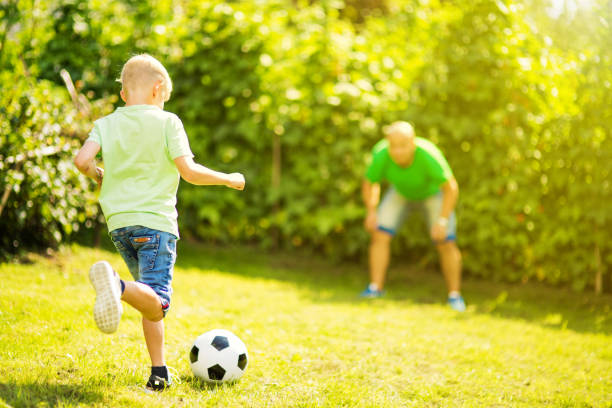 istock Son playing with his father footbal 1082925472
