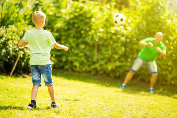 istock Son playing with his father footbal 1082925488