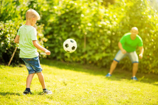 istock Son playing with his father footbal 1082925616