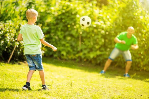 istock Son playing with his father footbal 1082925646