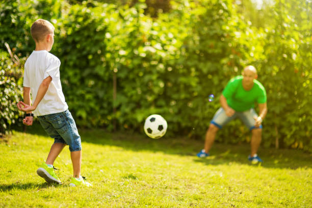 istock Son playing with his father footbal 1082925710