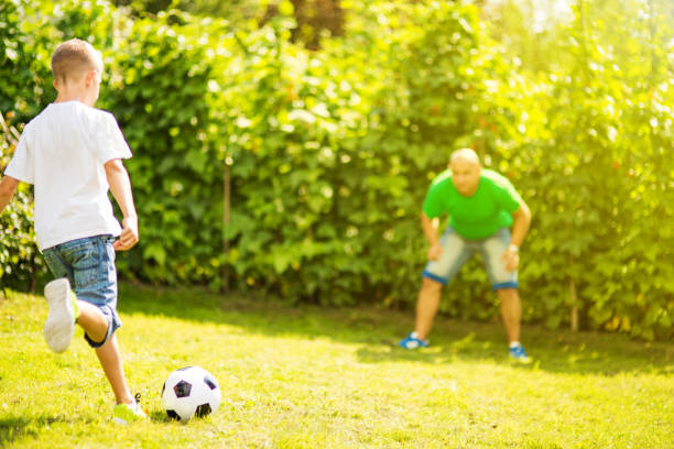 istock Son playing with his father footbal 1082925740