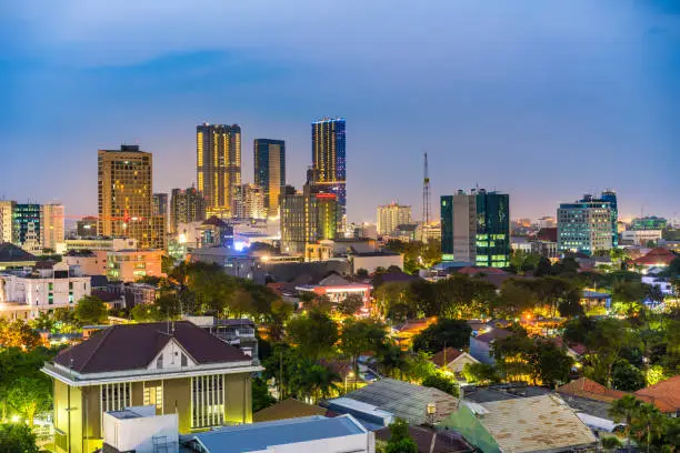 Surabaya, Indonesia - August 14, 2018:  view showing Surabaya City at night, buildings, towers, houses and trees can be seen on the background