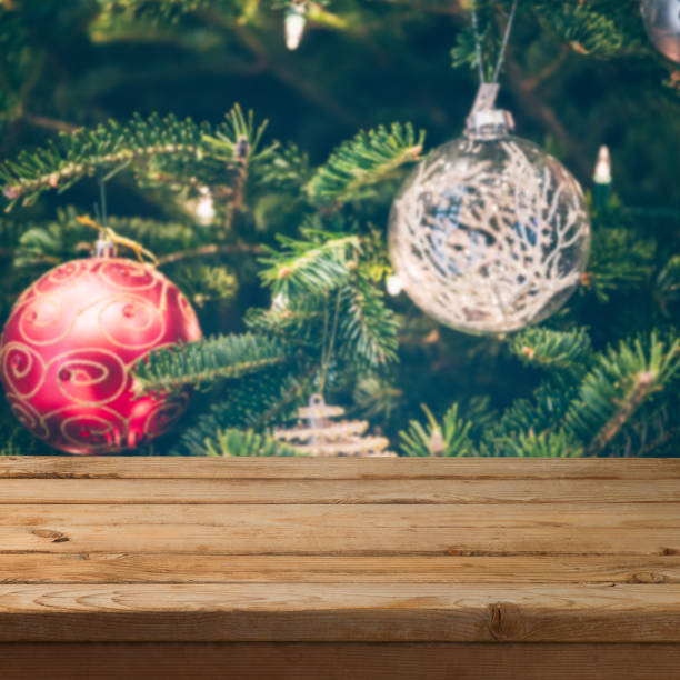 istock Christmas background with empty wooden table over Christmas tree decorations 1082937556