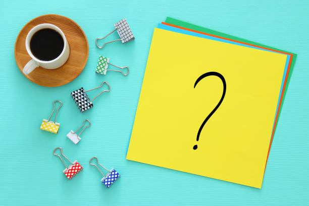 istock Question mark over yellow paper on office table. Searching for solution. confusion concept. 1082944748