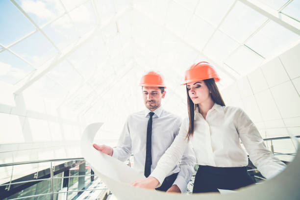 istock The two engineers hold the project plan in the building 1082947878