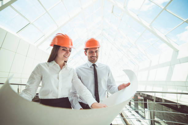 istock The two engineers hold the project plan in the building 1082948008