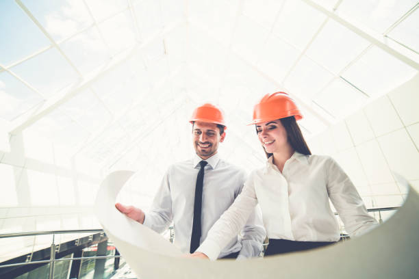 istock The two engineers hold the project plan in the building 1082948010