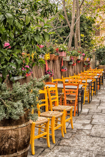istock Athens, Plaka district, colorful chairs and flowers 1082951176