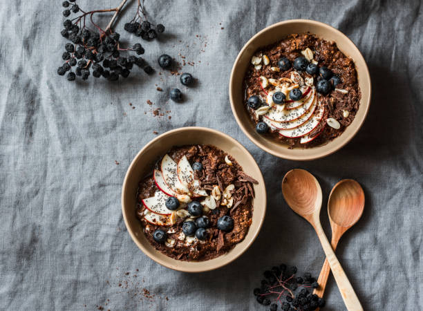 Chocolate overnight oat - healthy vegetarian breakfast on a grey background, top view. Flat lay, copy space