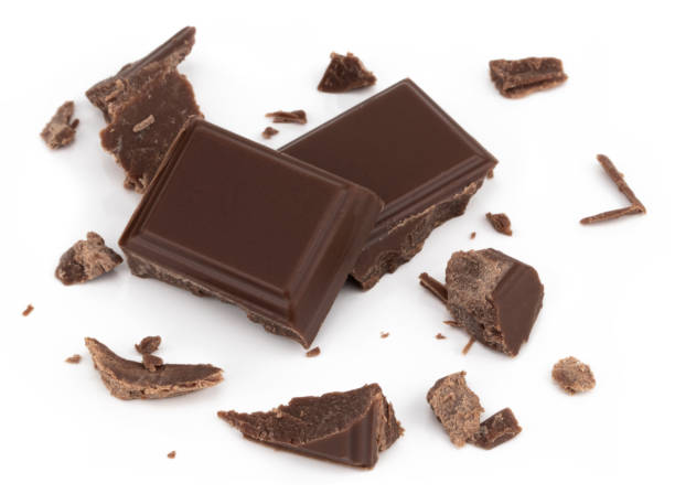 istock Milk chocolate pieces isolated on white background from top view 1082971088