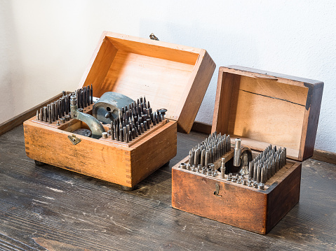 Old-fashioned archaic watch repair tools stored in quaint wooden box