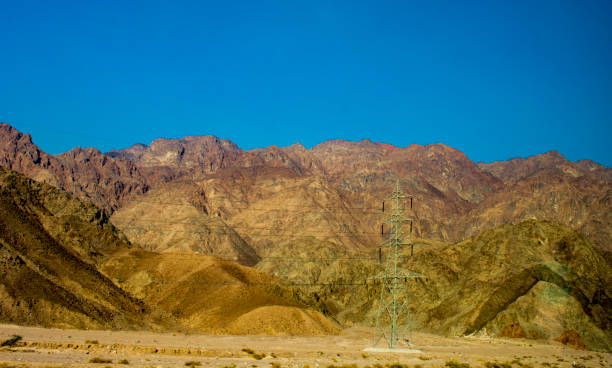 istock Power lines passing through the mountains of Egypt 1082990456