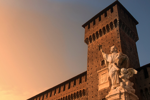 Castello Sforzesco, Milan, Italy. Castle at sunset. Beautiful statue