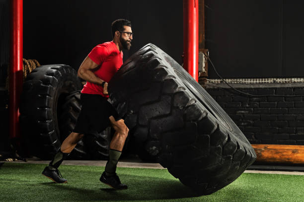 istock Strong sportsman doing  a tire flip exercise 1083004994