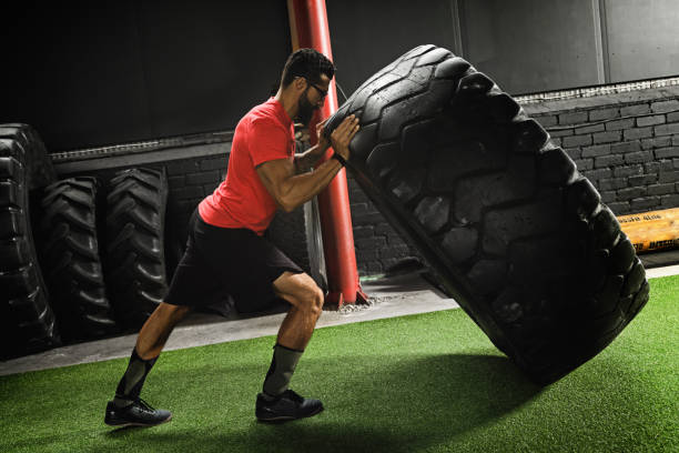 istock Strong sportsman doing  a tire flip exercise 1083005032