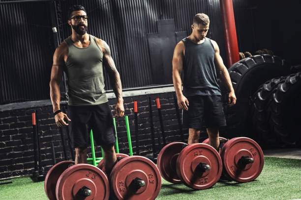 istock Muscular men during competition in the farmer's walk exercise 1083005922