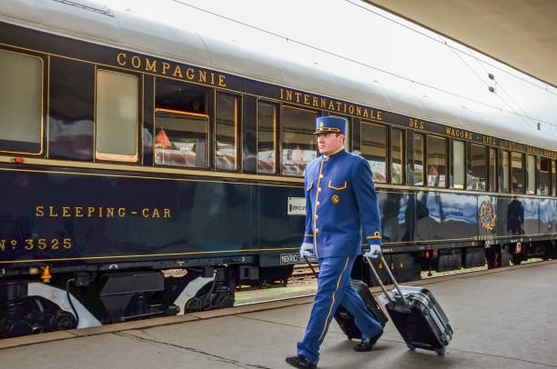 Venice Simplon Orient-Express in Prague Prague, Czech Republic, October 4, 2012: The Orient-Express a arrived at Prague Smichov Station. A wagon conductor transports passengers' luggage for hotel transfer. The Venice Simplon-Orient-Express, is a private luxury train service, known as the Orient Express. europa mythological character photos stock pictures, royalty-free photos & images