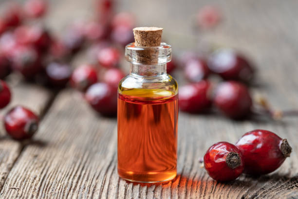 istock A bottle of rose hip seed oil with dried rose hips 1083027708